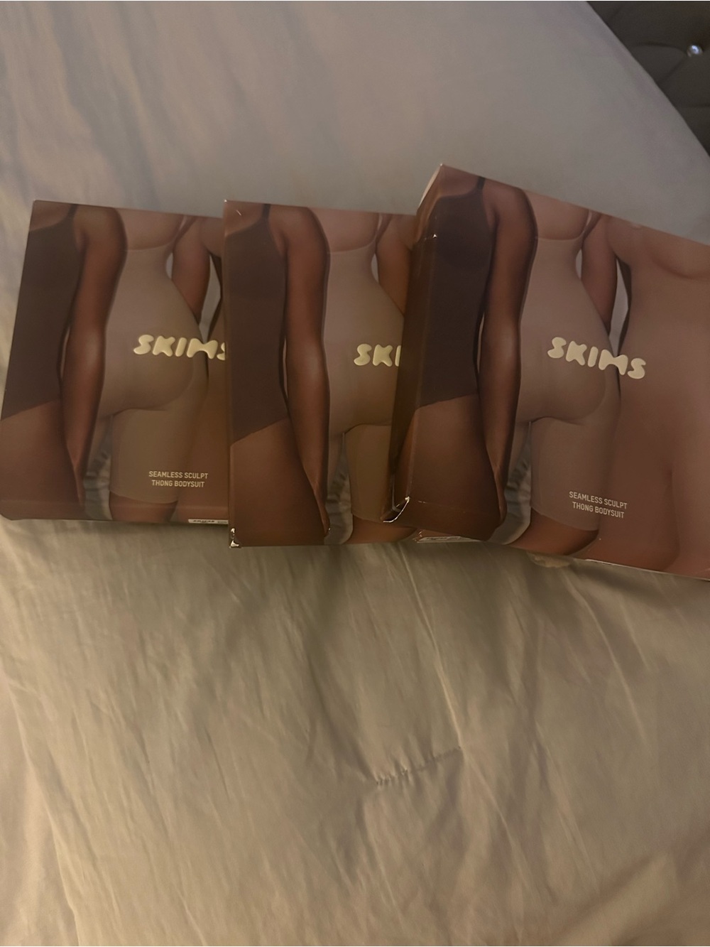 Set of 3 SKIMS Seamless Sculpt Thong Bodysuits in colors Bronze, Sand and Jasper